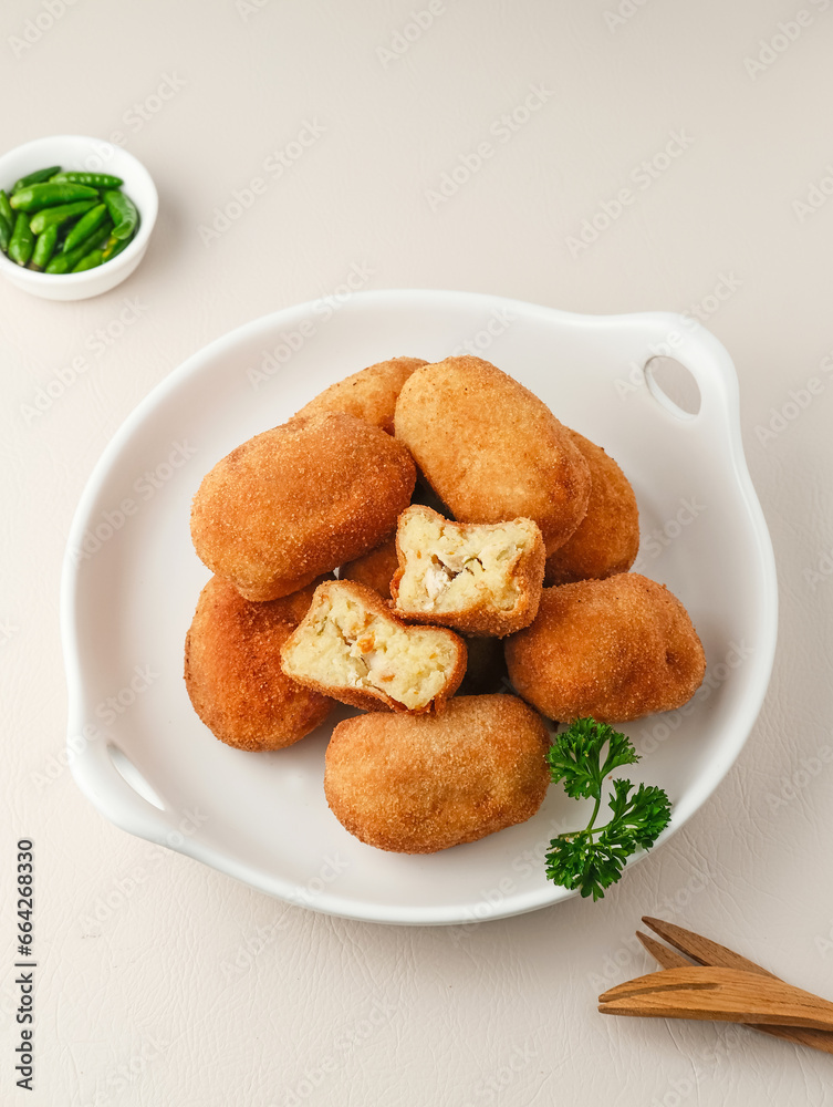 Croquettes, consisting of chicken and ragout coated with egg and panir flour and then fried. 
