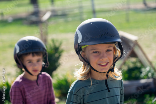 Two children happy with riding helmets © Arianne