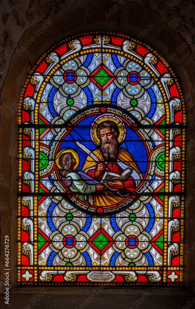 Val d'Oingt, France - 08 29 2021: Rhône Vineyard. View of the stained glass medallion of Saint Matthew in the church of Oingt, medieval building.