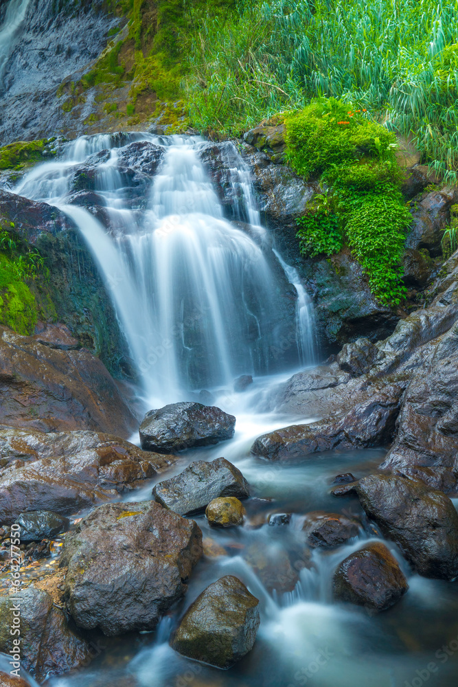 The photo of the Air Terjun Sikarim waterfall in Dieng, Indonesia.