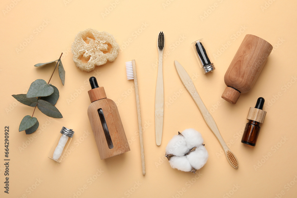 Flat lay composition with bamboo toothbrushes on pale orange background Flat lay composition with bamboo toothbrushes on pale orange background