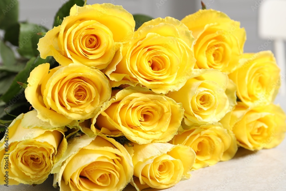 Beautiful bouquet of yellow roses on light grey table, closeup Beautiful bouquet of yellow roses on light grey table, closeup