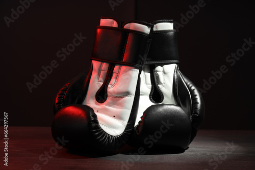 Boxing gloves are illuminated with red light © Atlas