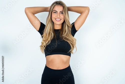 Satisfied caucasian woman wearing sport clothes hold hands behind head relaxing © Roquillo