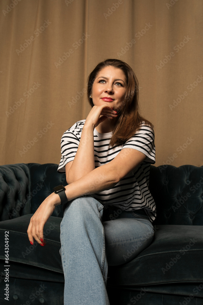 Front portrait of a girl who is thinking about something, puts her hand near her chin. Front portrait of a girl who is thinking about something, puts her hand near her chin.