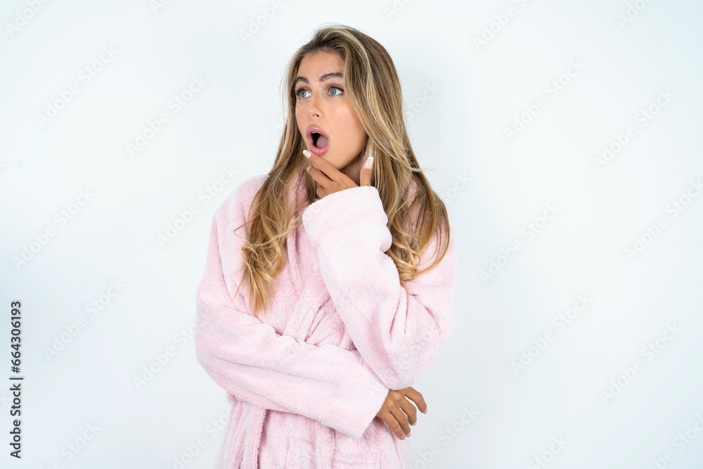 Astonished Young beautiful woman looks aside surprisingly with opened mouth. Astonished Young beautiful woman looks aside surprisingly with opened mouth.