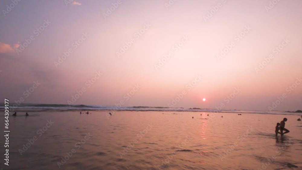 Evening landscape on a tropical island. The sunset sky and its reflection in the ocean waves Evening landscape on a tropical island. The sunset sky and its reflection in the ocean waves