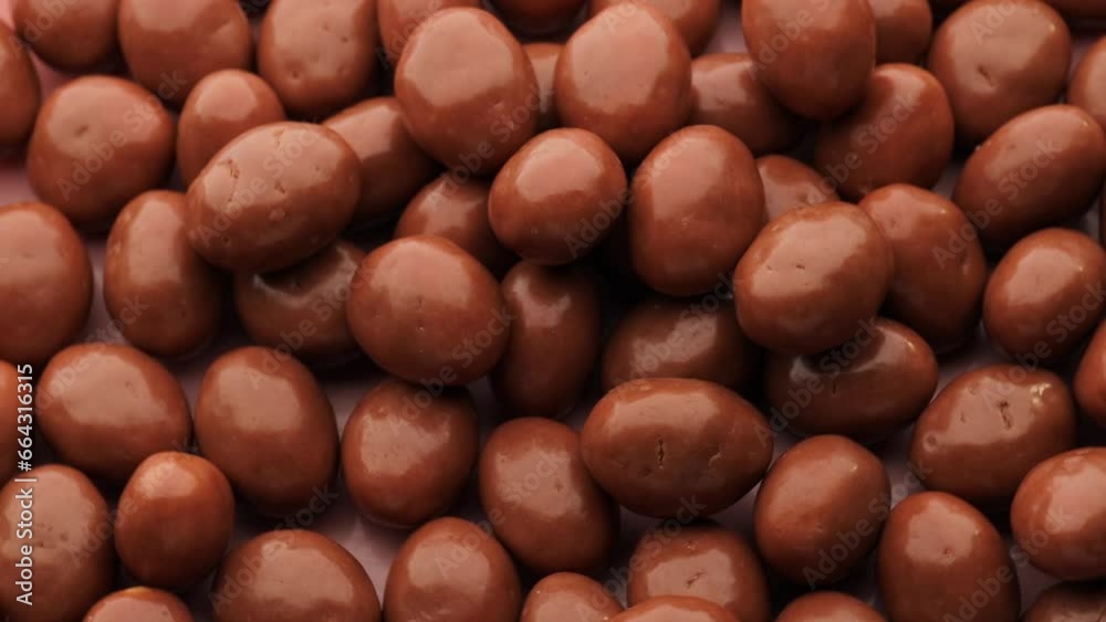 Pistachios covered in chocolate, rotation in circle. Nuts in chocolate, Turning. chocolate background. Chocolate coated nut Pistachios covered in chocolate, rotation in circle. Nuts in chocolate, Turning. chocolate background. Chocolate coated nut
