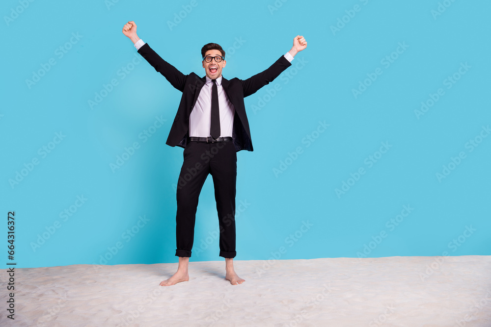 Full length photo of positive cheerful clerk guy dressed black tuxedo waiting going vacation empty space isolated blue color background Full length photo of positive cheerful clerk guy dressed black tuxedo waiting going vacation empty space isolated blue color background
