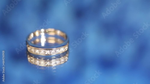 White gold ring set with diamonds photographed on blue photo