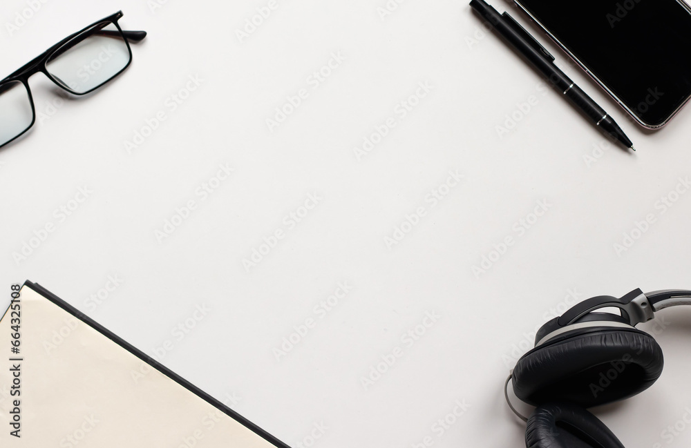 Top view of some office supplies with empty middle on white backdrop. Flat lay. Copy space for the text. Top view of some office supplies with empty middle on white backdrop. Flat lay. Copy space for the text.