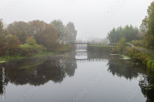 A canal lock gates on the Forth the Clyde canal on a cold and misty winter in Glasgow Scotland