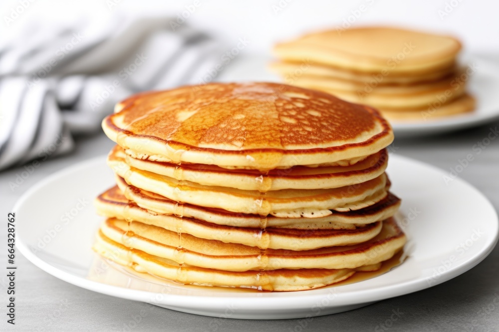 stacks of plain pancakes on a plain white plate stacks of plain pancakes on a plain white plate