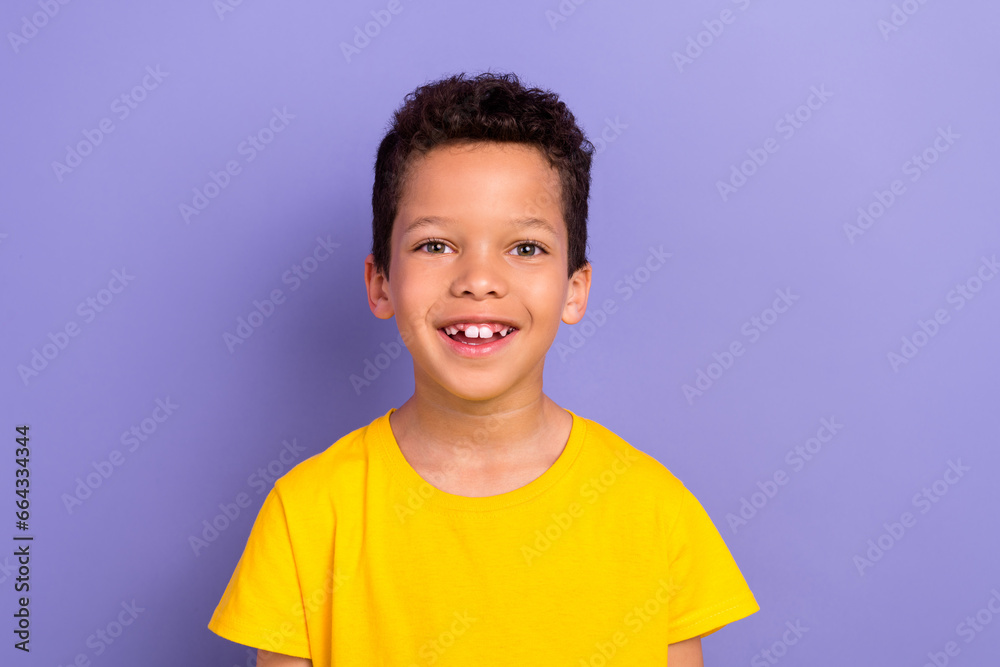 Photo of cheerful funky hispanic boy wear yellow clothes have good mood isolated on purple color background Photo of cheerful funky hispanic boy wear yellow clothes have good mood isolated on purple color background