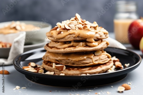 vegan apple-cinnamon pancakes with a dollop of peanut butter