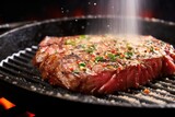 close-up of seasoning sprinkled on a sizzling steak