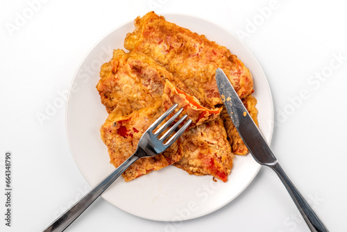 Breaded Peppers (Pohovane Paprike), Balkan cuisine specialty. Fried paprika served on a plate with knife and fork photo