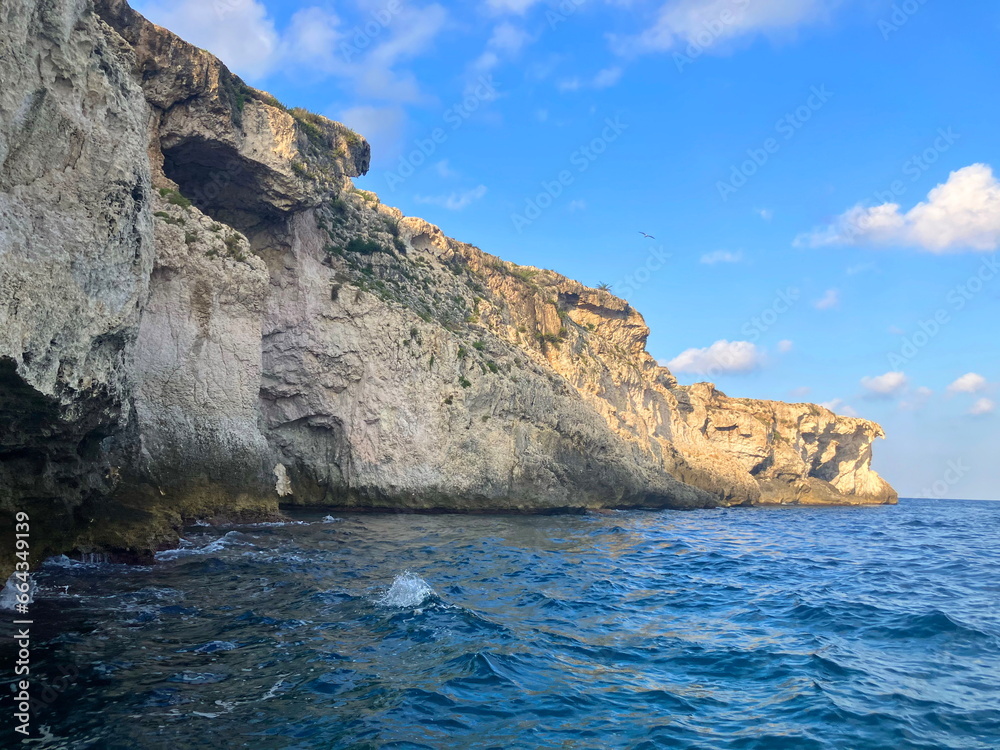 Sea grottoes and caves of Sicily. Sea Caves Tour Ortigia in Siracusa.  Sea grottoes of Syracuse. Boat trip in Sicily, coastal cliffs