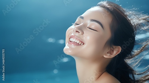 Skin care. Woman with beautiful face touching healthy facial skin. Beautiful portrait of smiling Asian girl model with natural make-up.