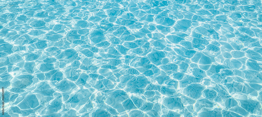 Surface of blue swimming pool, background of water in swimming pool. Blue ripped water in swimming pool. Abstract summer background concept. Fun relaxation carefree copy space wallpaper