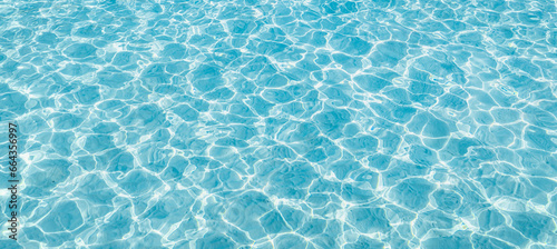 Surface of blue swimming pool  background of water in swimming pool. Blue ripped water in swimming pool. Abstract summer background concept. Fun relaxation carefree copy space wallpaper