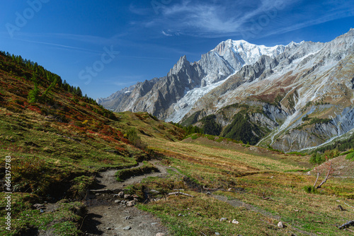 Mont Blanc, the highest top of the Alps, seen by the paths of the Val Ferret, during a sunny October day, near the town of Courmayeur, Valle d'Aosta, Italy - October 2023