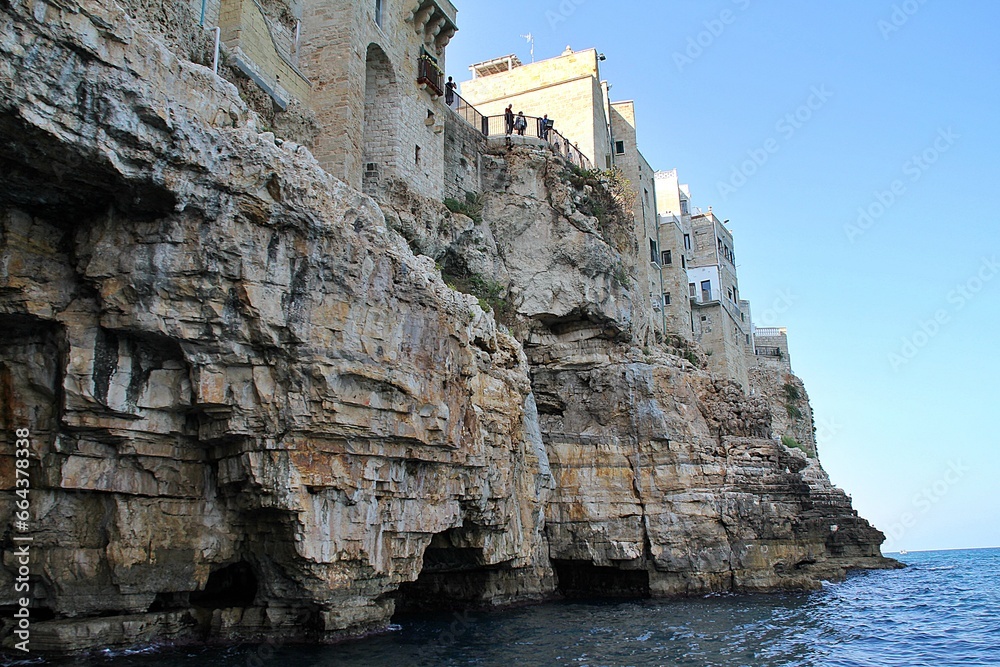  rocky coast, plateau falling into the sea, Polignano a Mare, houses built on the coast, blocks of rock, Puglia region in Italy