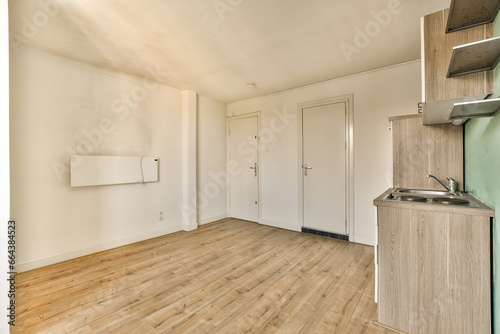 an empty living room with wood flooring and white walls in the room is very clean, ready to use