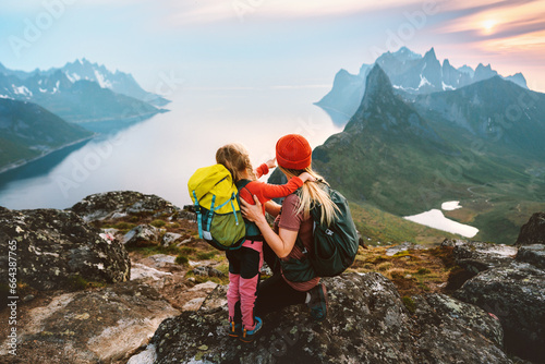 Mother hiking with kid daughter family travel hobby active vacations outdoor in Norway healthy lifestyle in mountains woman with child enjoying views of Senja island Mother's day holiday