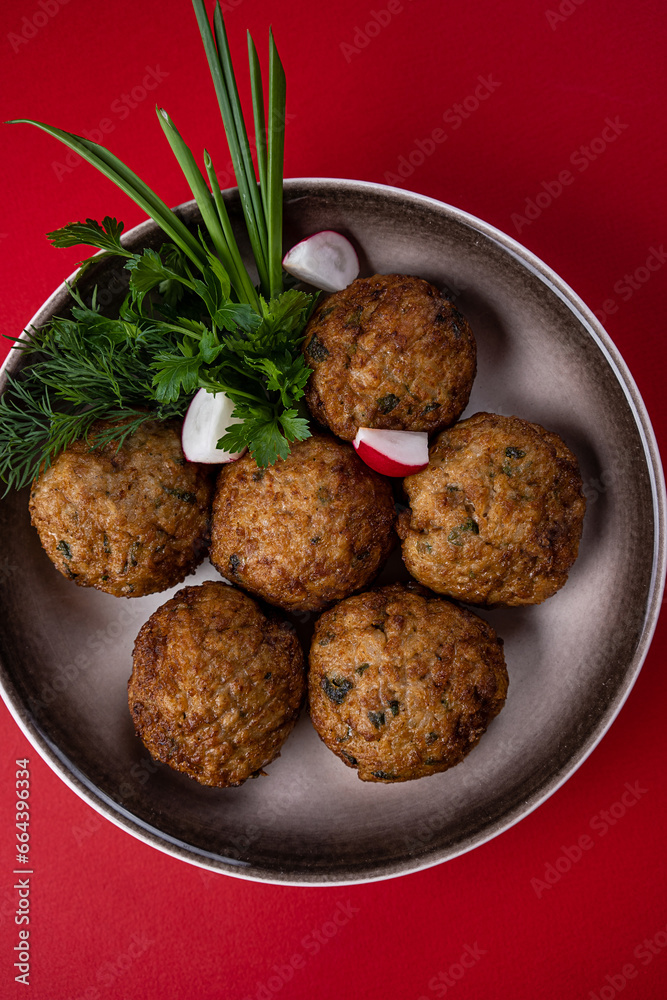 Hot, Juicy Beef Meat Patties on a Plate against a Red Background