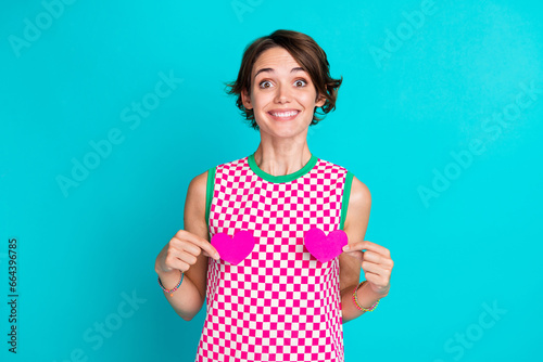 Photo of charming young lady wear trendy dress holding two small gifts postcards heart figure hide chest isolated on blue color background