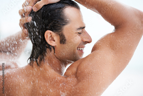 Shower, happy and man with water for cleaning, washing hair and grooming for healthy skin. Beauty, spa treatment and person smile with splash for hygiene, wellness and skincare hydration and cleanse