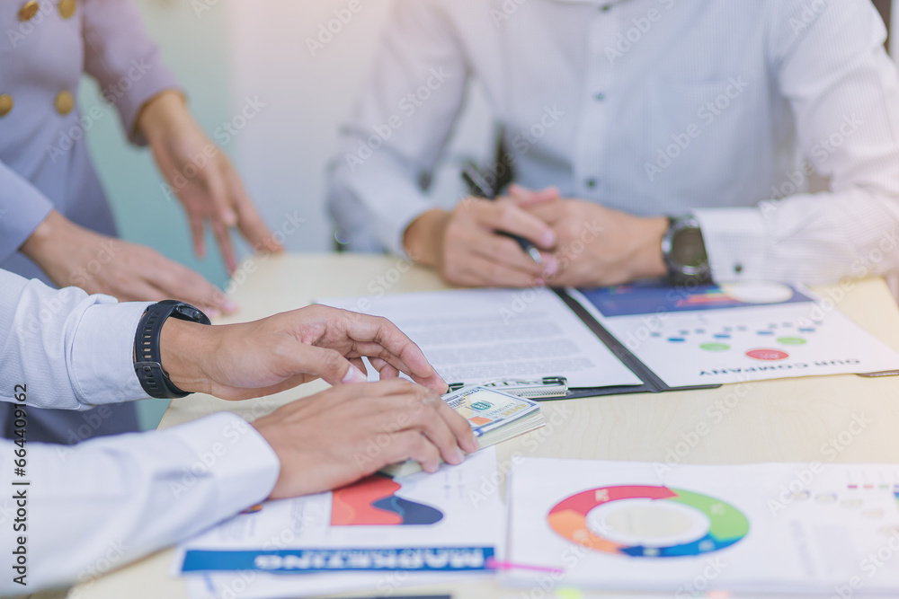 Businesspeoples meeting to discuss the situation on business plan, marketing and business investment. Selected focus Businesspeoples meeting to discuss the situation on business plan, marketing and business investment. Selected focus
