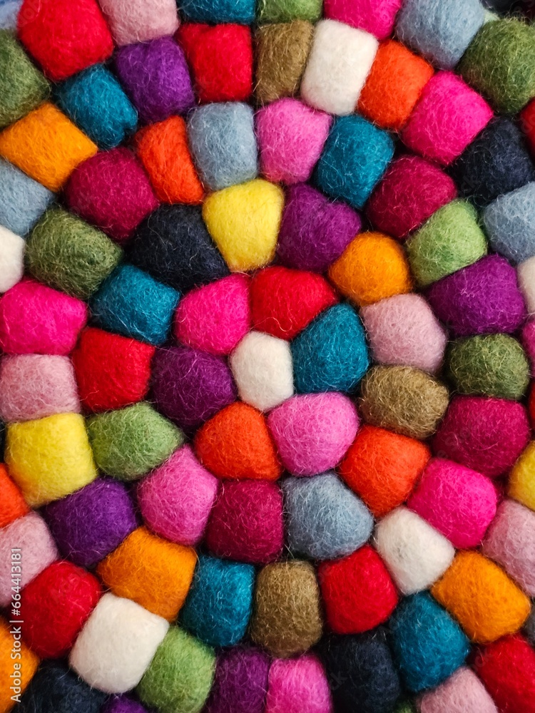 wool balls, with various hues intertwined to create a colorful and eye-catching pile. wool balls, with various hues intertwined to create a colorful and eye-catching pile.