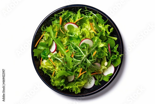 Healthy fresh green salad plate shot from above on white background. photo