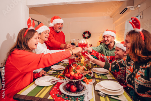 Group of happy family smiling happy celebrating christmas toasting with wine. Family member enjoy home made turkry grill dining togather at home. Christmas and New Year interior concept. photo