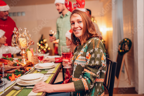 Happy family smiling happy celebrating christmas toasting with wine. Family member enjoy home made turkry grill dining togather at home. Christmas and New Year interior concept. photo