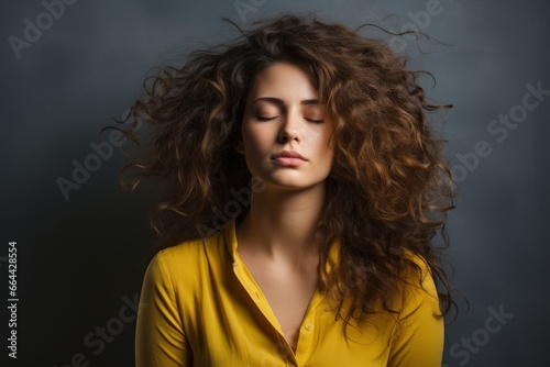 Curly-haired woman in yellow top