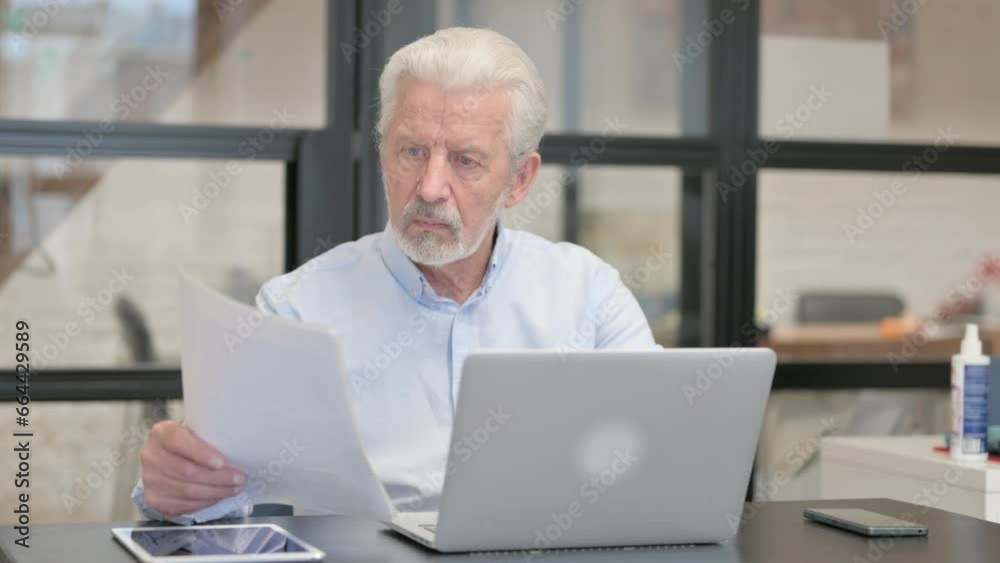 Old Businessman Working on Documents and Laptop Old Businessman Working on Documents and Laptop
