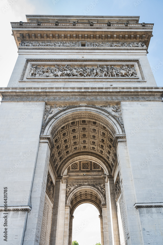Arc de Triomphe, one of the most famous monuments in Paris, massive triumphal arch, located near Champs-Elysees in Paris. Close up, selective focus