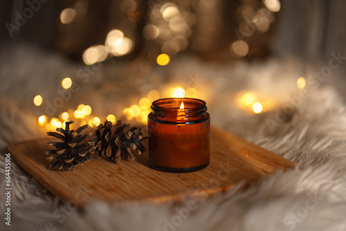 Natural soy candle in dark glass jar on dark gray background romantic atmosphere 