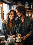 Smiling loving couple being happy and drinking coffee - modern concept of lifestyle with cappuccino and laughter