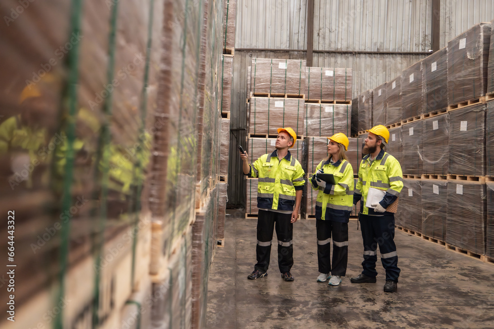 Warehouse staff verify wooded pallets items using handheld device, ensuring precise shipment. Warehouse staff verify wooded pallets items using handheld device, ensuring precise shipment.