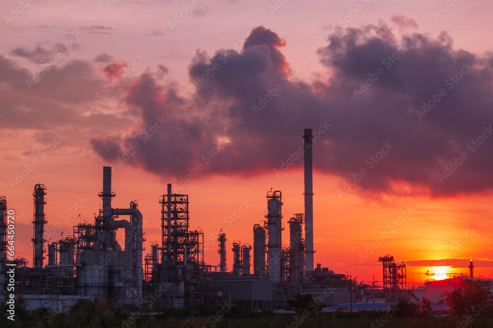 Oil​ refinery​ and​  plant and tower column of Petrochemistry industry in pipeline oil​ and​ gas​ ​industrial with​ cloud​ slowing red sky