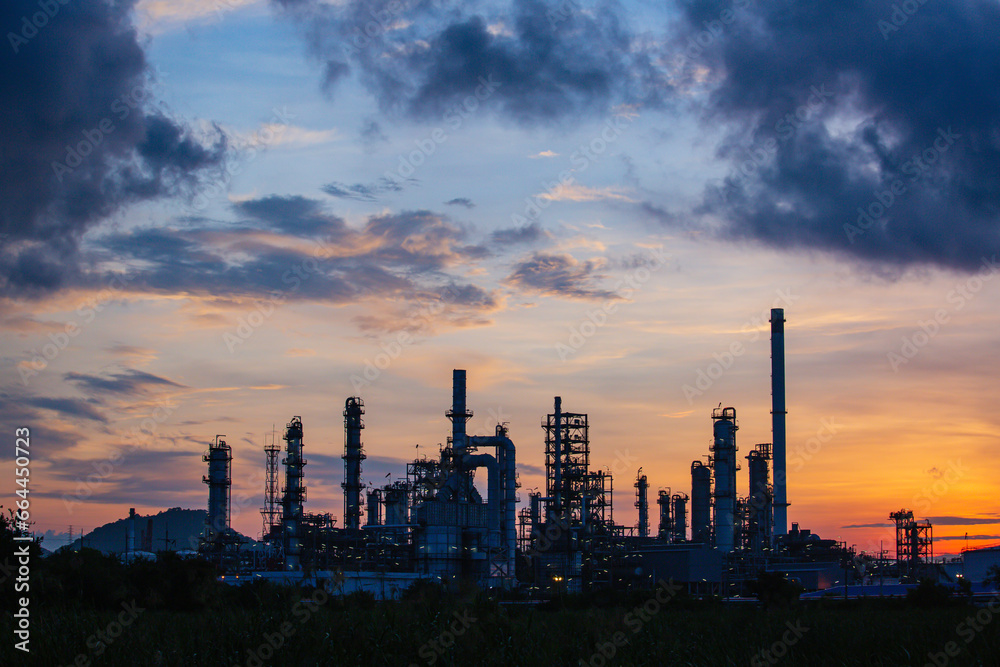 Oil refinery and plant and tower column of Petrochemistry industry in pipeline oil and gas industrial with cloud slowing red sky Oil refinery and plant and tower column of Petrochemistry industry in pipeline oil and gas industrial with cloud slowing red sky
