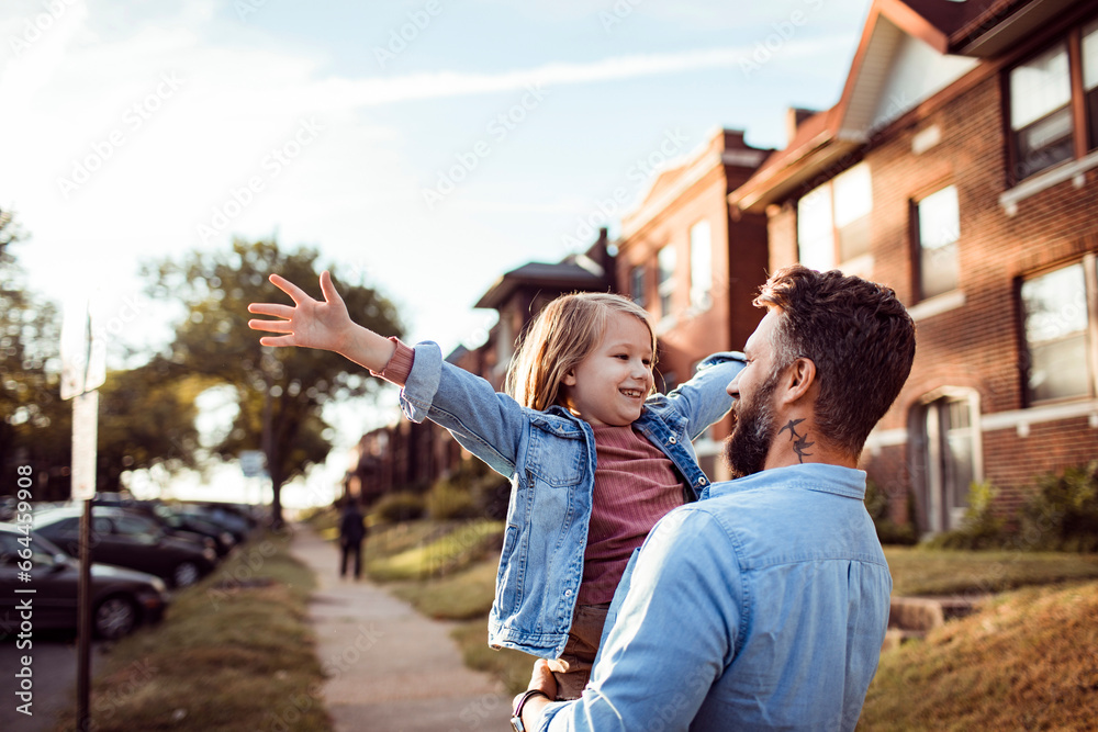 Naklejka premium Loving young father holding his father in the street