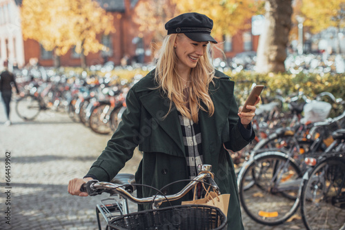 Attractive young woman using a smartphone in the city