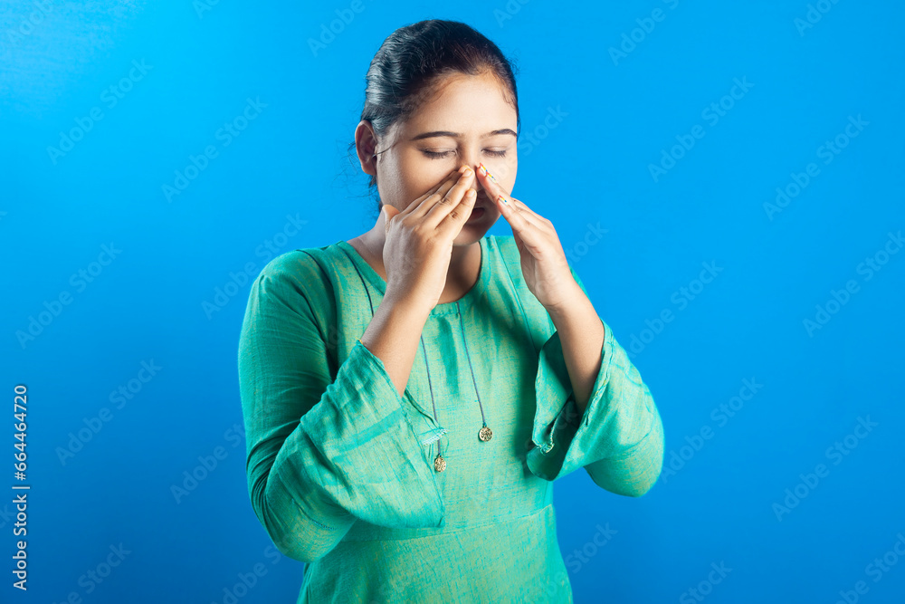 Sinus pain, cold, illness. Indian women holding her nose due to sinus pain Sinus pain, cold, illness. Indian women holding her nose due to sinus pain