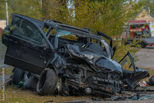 The driver lost control and flew off the road. Serious accident. Black car. The driver was injured. Damage. Close-up, details. © Denis Chubchenko