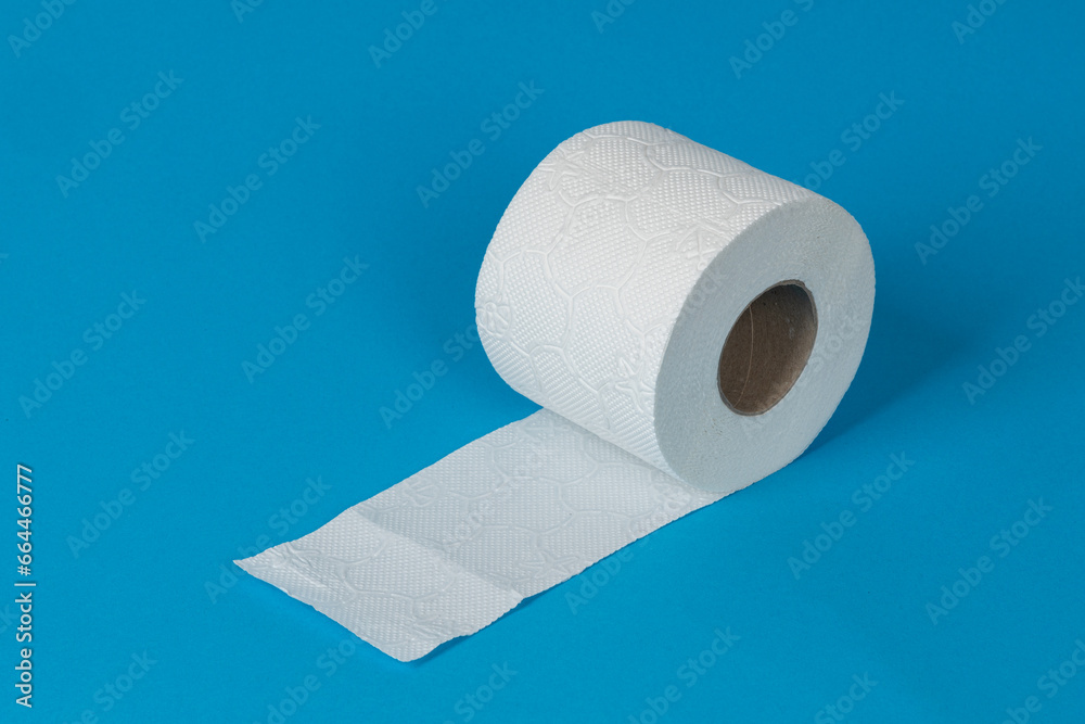 Obraz premium One roll of white toilet paper on blue background